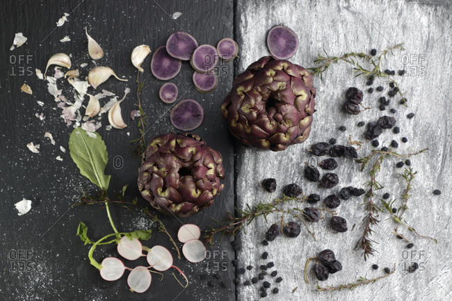 Still life made of artichokes and violet vegetables and berries