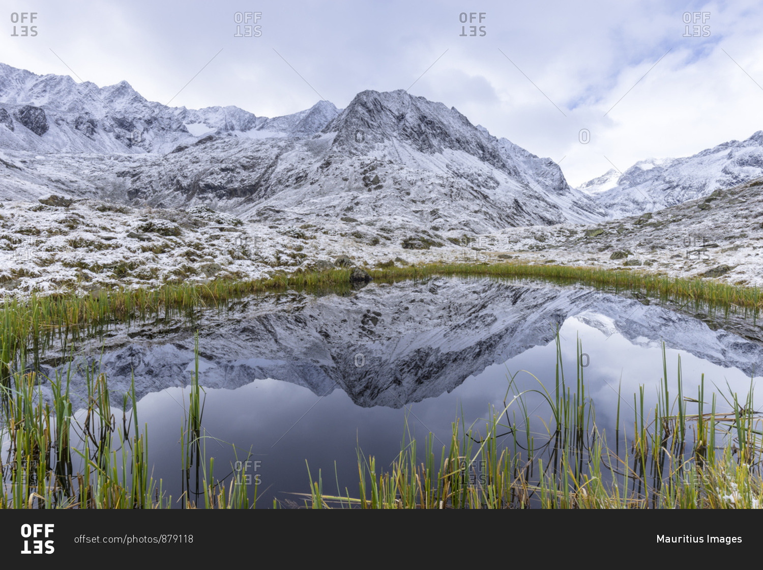 Austria, tyrol, the stubai alps, neustift, mirroring of the alpeiner mountains in a small lake near the franz-senn-h�tte (hut)