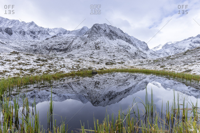 Austria, tyrol, the stubai alps, neustift, mirroring of the alpeiner mountains in a small lake near the franz-senn-h�tte (hut)