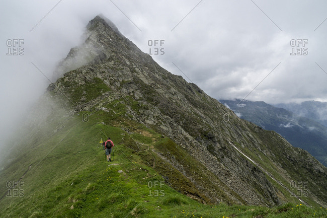 Austria, tyrol, the stubai alps, neustift, hiker on a ridge in the hiking region of the elfer massif in stubai