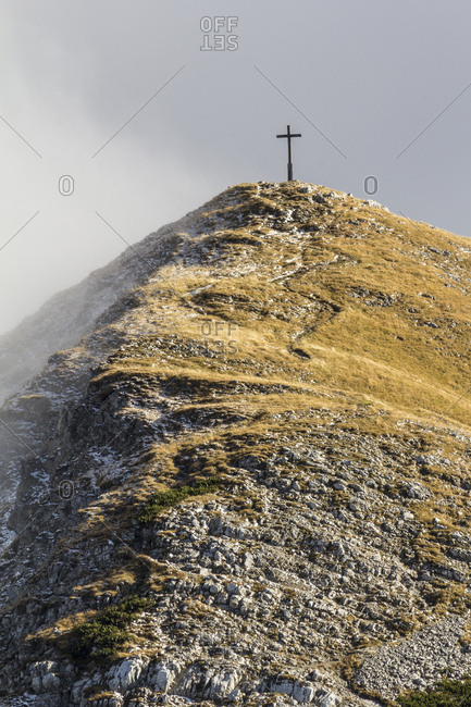 Germany, bavaria, bavarian alps, garmisch-partenkirchen, summit cross of the krottenkopf with the weilheimer hut in the estergebirge