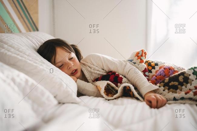 Girl lying in bed having an afternoon nap