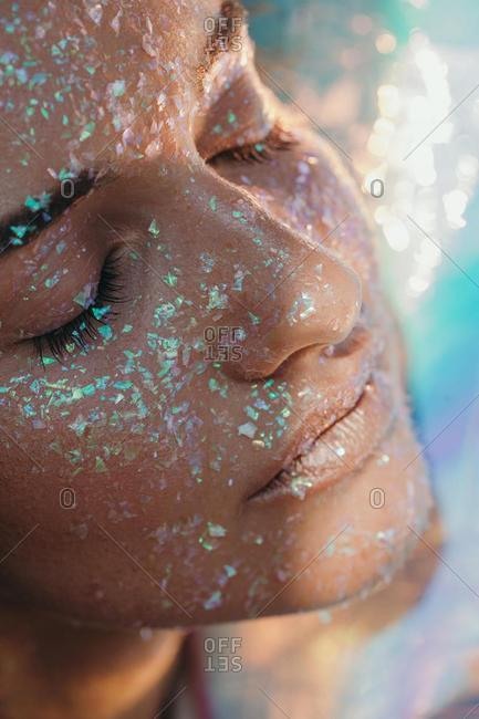 Portrait of a beautiful woman covered in glitter