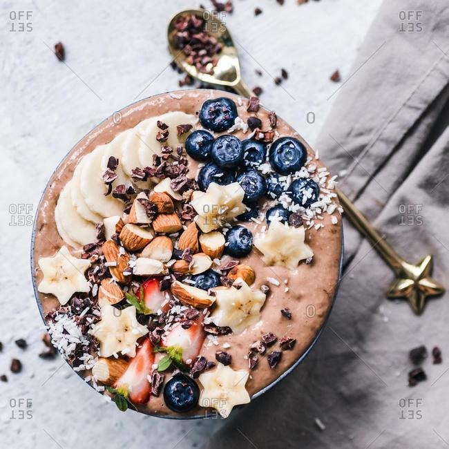 Chocolate smoothie bowl with fresh fruit and nuts