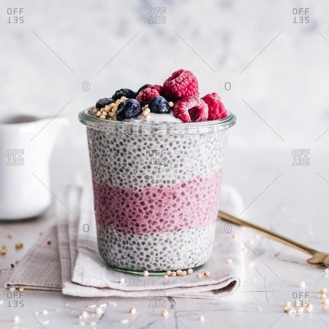 Coconut, raspberry and blueberry chia pudding with yogurt