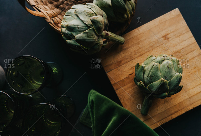 Top view of artichoke on a wooden cutting board