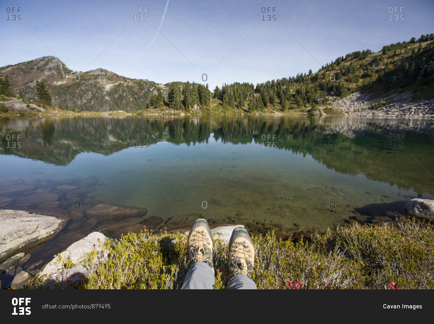 Mountaineering boots in front of picturesque alpine tarn, B.C.