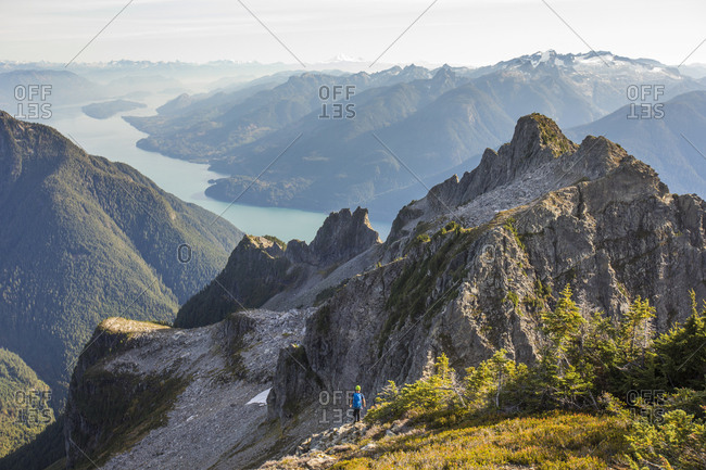 Lone climber looking over Coast Mountains and Harrison Lake, B.C.