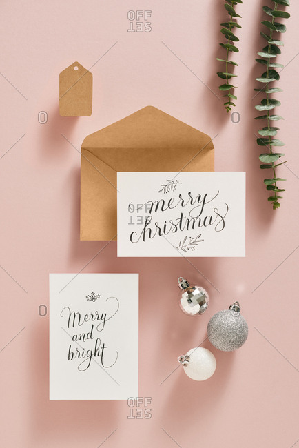 Christmas card with ornaments, leaves and envelope.
