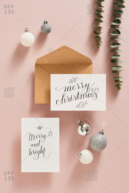 Christmas card with ornaments, leaves and envelope.