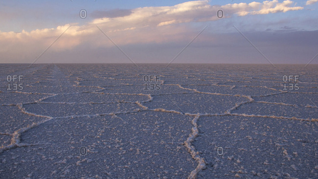 Scenic view of Salar de Uyuni against cloudy sky