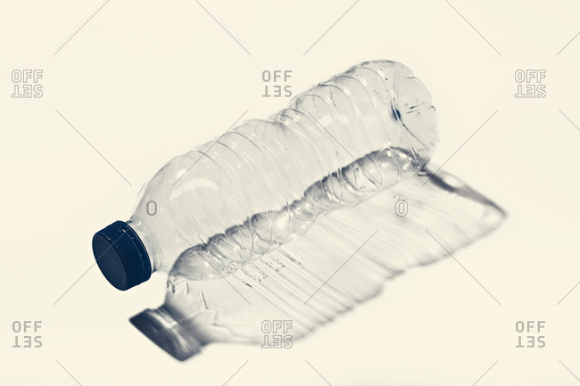 Premium Photo  Cold water in a plastic bottle with a blue cap on black  background