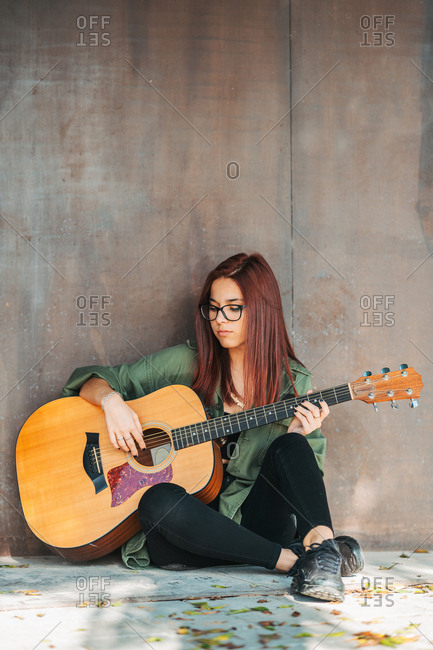 Hippie girl sitting in lotus pose front guitar Vector Image