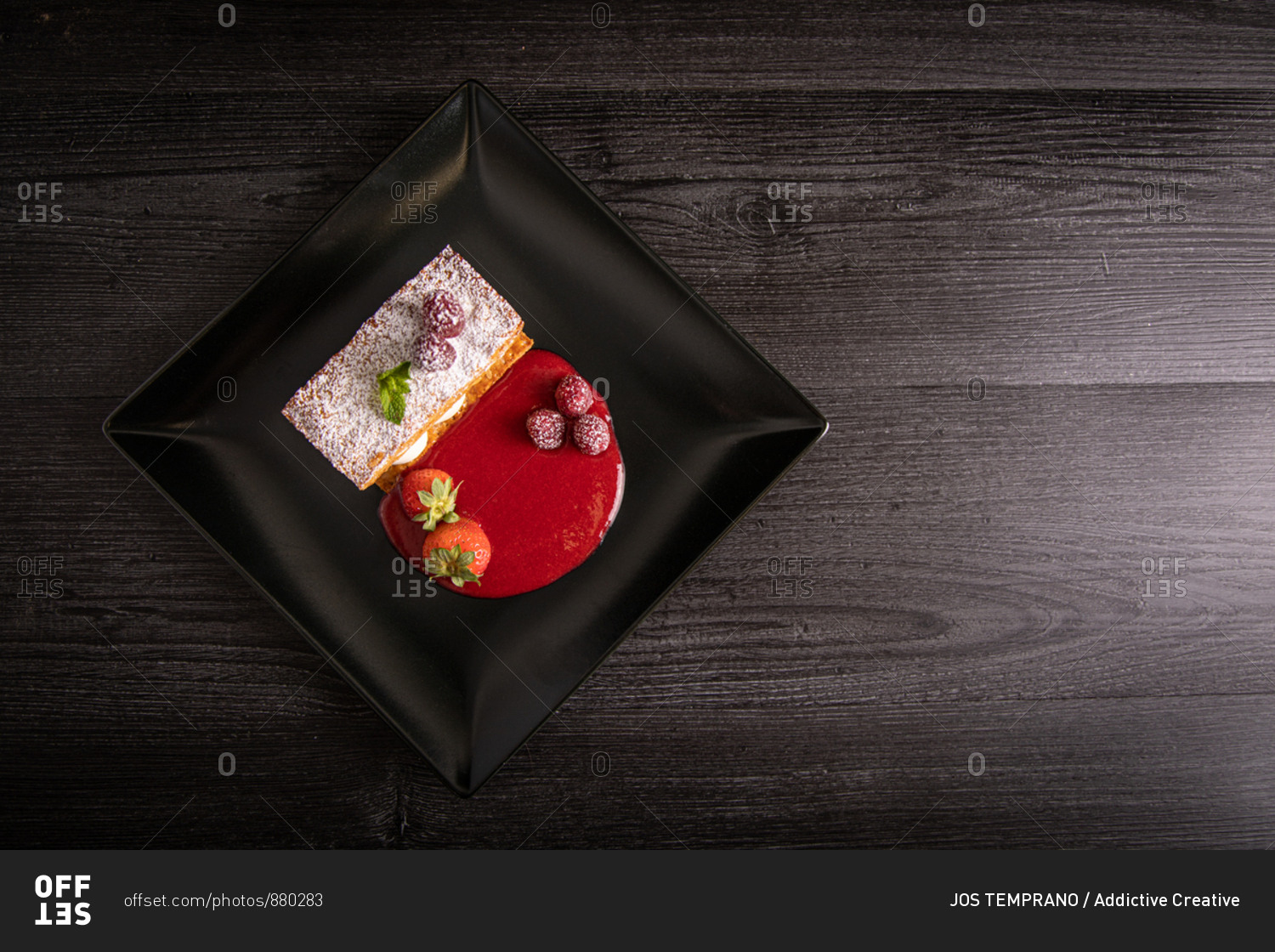 Diplomat cream and red fruit strudel in elegant black plate
