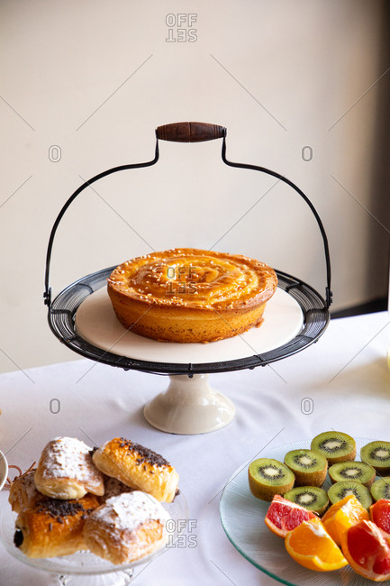 From above stylish table mate with grip and tasty pie on table with dishes