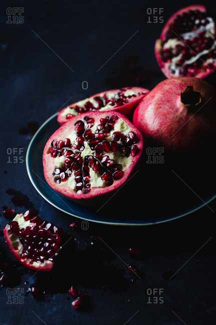 Still Life of Opened Pomegranates in Dark and Moody Background