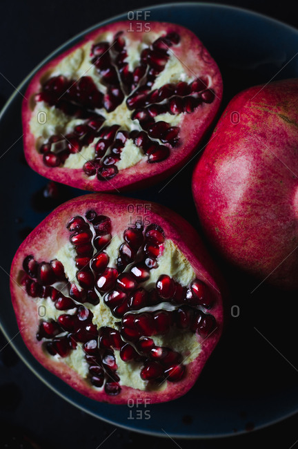 Still Life of Opened Pomegranates With One Whole Pomegranate