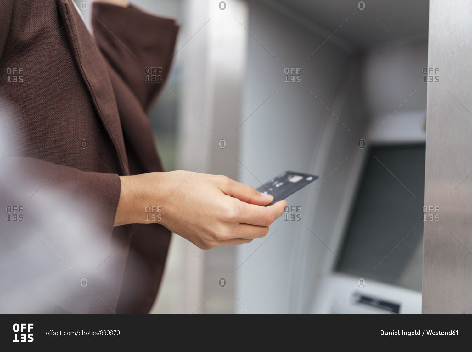 Close-up of businesswoman withdrawing money at an ATM