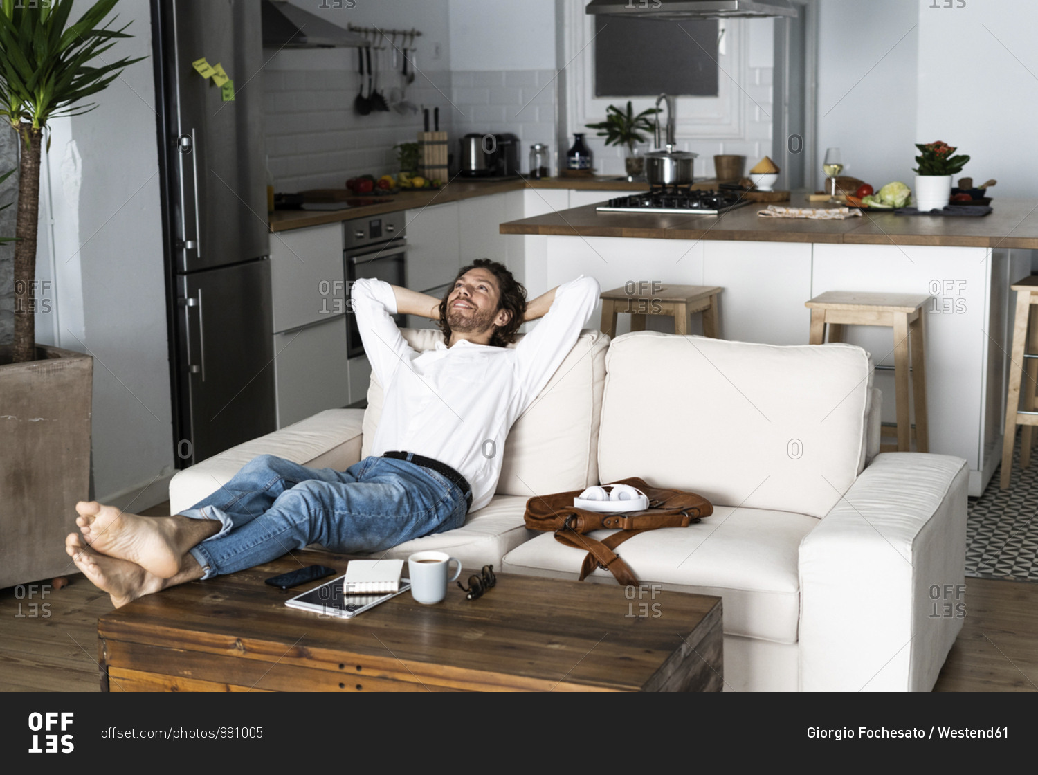 Relaxed Man Leaning Back On Couch At