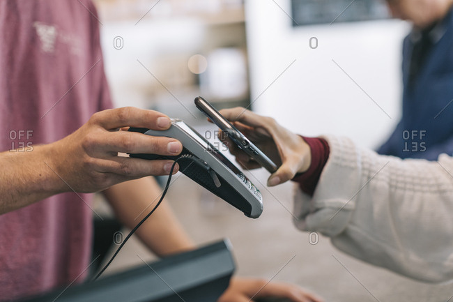 Woman making NFC payment with her phone