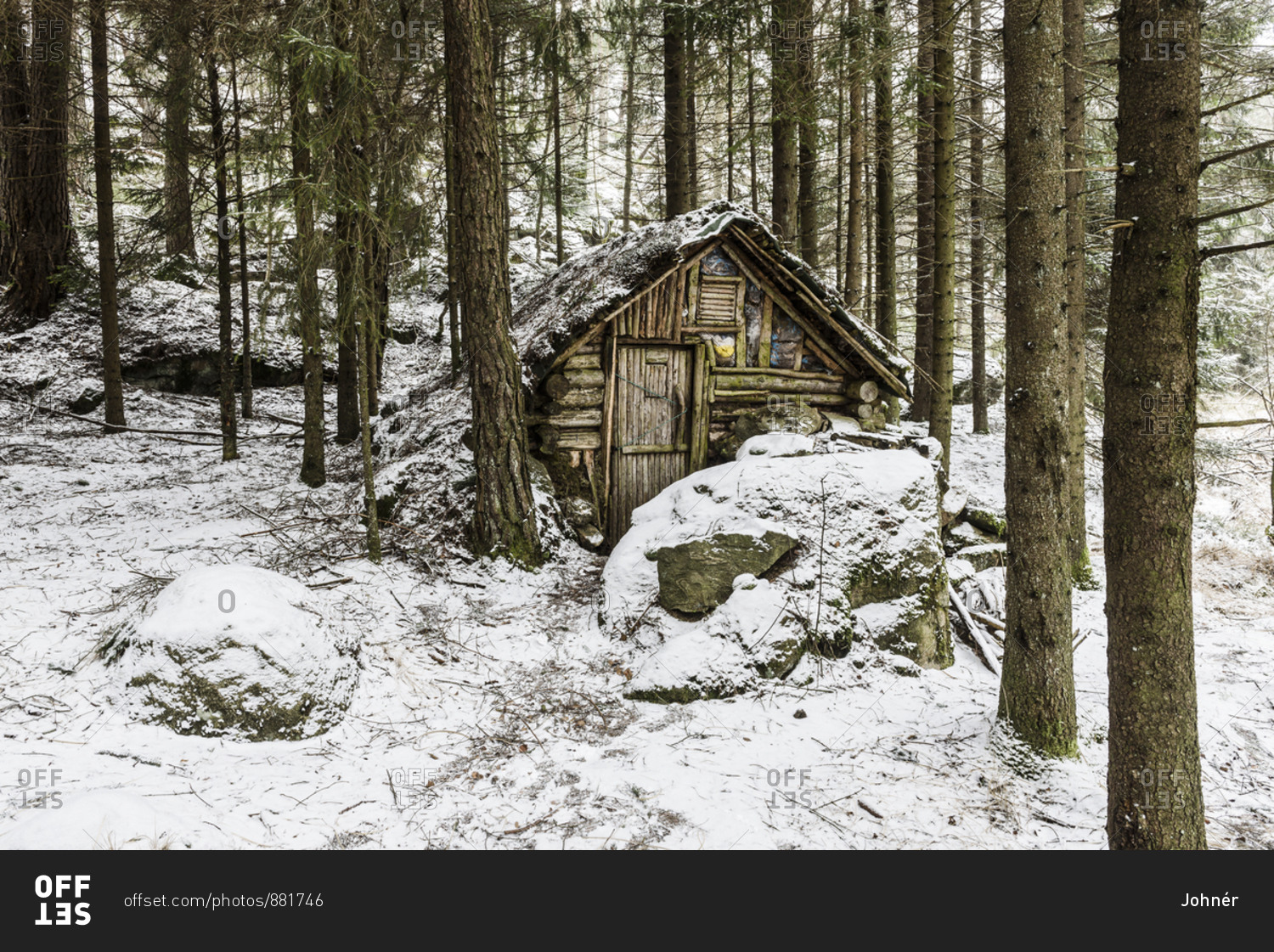 Wooden hut in winter forest