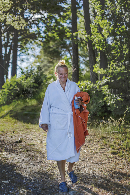Woman wearing dressing gown holding towel