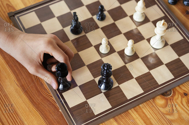 Hand holding chess piece