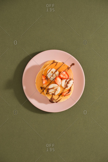 Homemade pancakes topped with strawberries and bananas