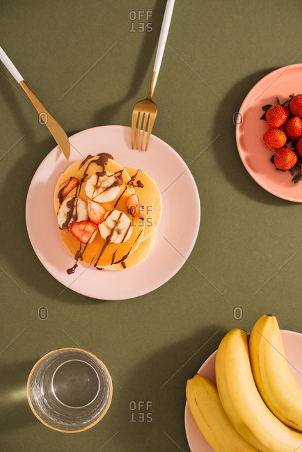 Homemade pancakes topped with strawberries and bananas