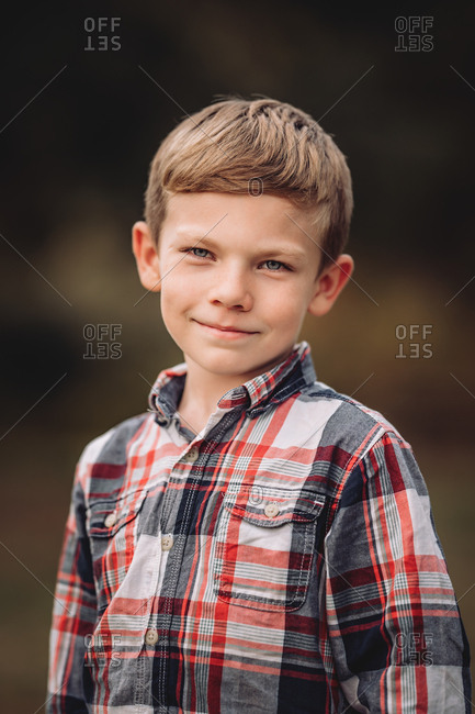 Happy boy wearing a plaid shirt