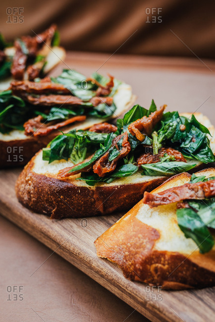 Sun dried tomato bruschetta on a wooden board