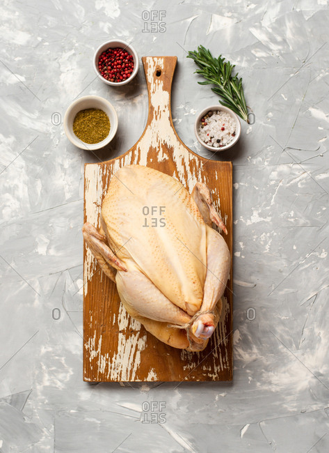 Premium Photo  Raw chicken on a cutter board with vegetables and spices