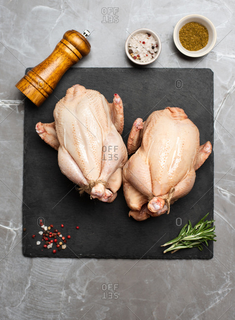 Two whole raw chickens and spices