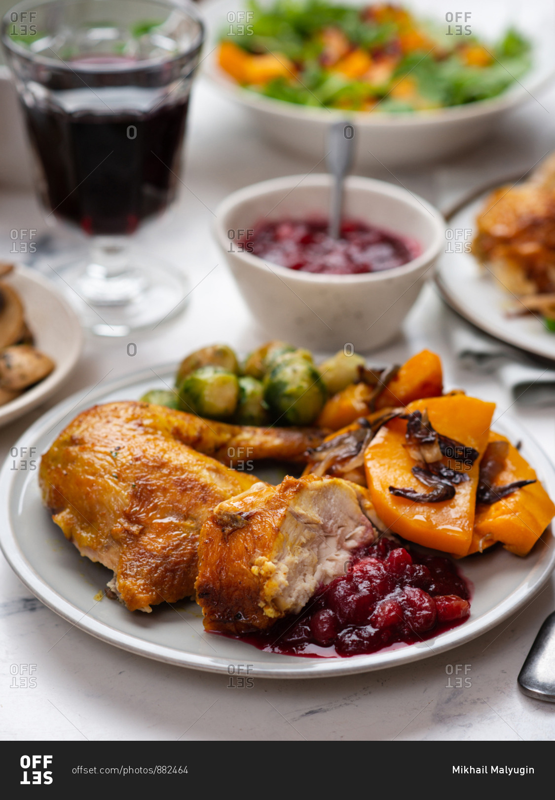 Thanksgiving dinner with roasted chicken and sides stock photo - OFFSET