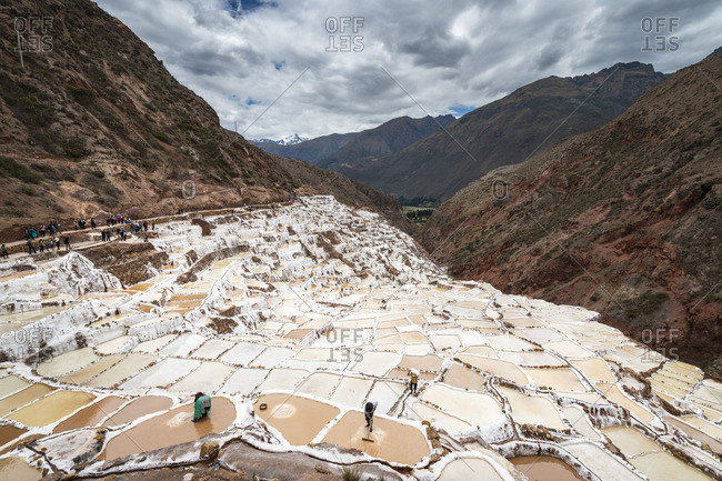 Elevated view of workers at Maras salt marsh terraces, Salinas de Maras, Cuzco Region, Peru