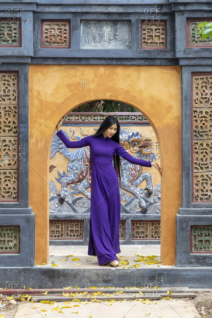 Vietnam - March 24, 2019: A Vietnamese woman in an Ao Dai dress at the Tu Duc Tomb, Hue,  Hue, Thua Thien-Hue province, Vietnam