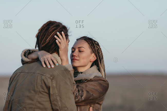 Young couple with dread locks embracing in nature, Lleida, Spain