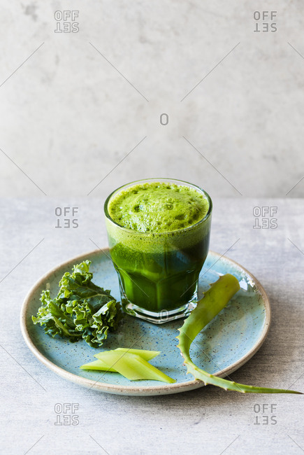 Freshly squeezed green juice with ingredients