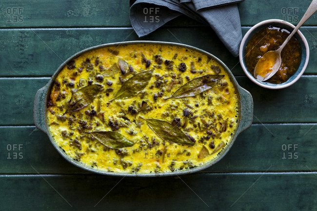Overhead view of a South African Bobotie dish with curried ground beef, baked with a rich savory custard