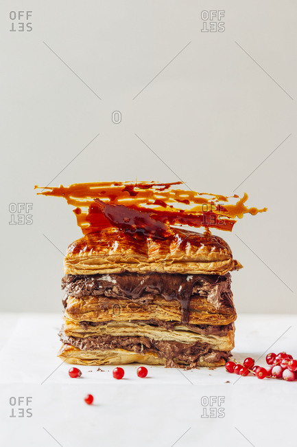 Chocolate and caramel puff dough dessert with fresh cranberry