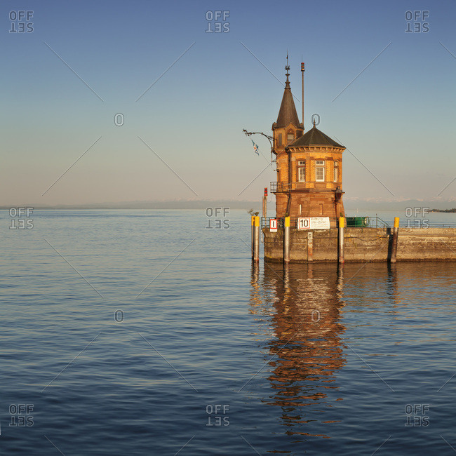 Port entrance of constance with view to the swiss alps at sundown, lake constance, baden-wuerttemberg, Germany