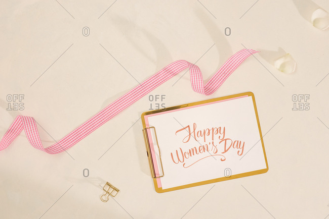 Hand writing script and vintage ribbon on white background for mother day. Flatlay, top view