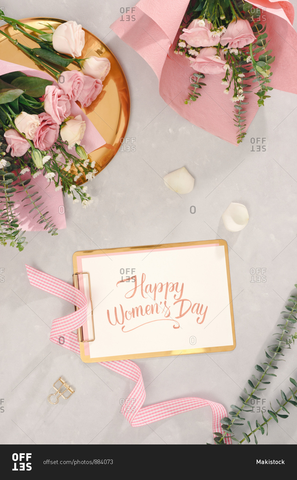 Happy women\'s day with hand writing script, flower bouquets on light background. top view, flatlay.