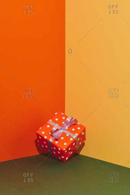 Colorful gift boxes with ribbons on color tabletop