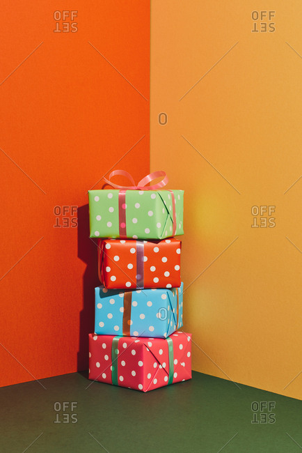 Birthday gift boxes with ribbons on color tabletop