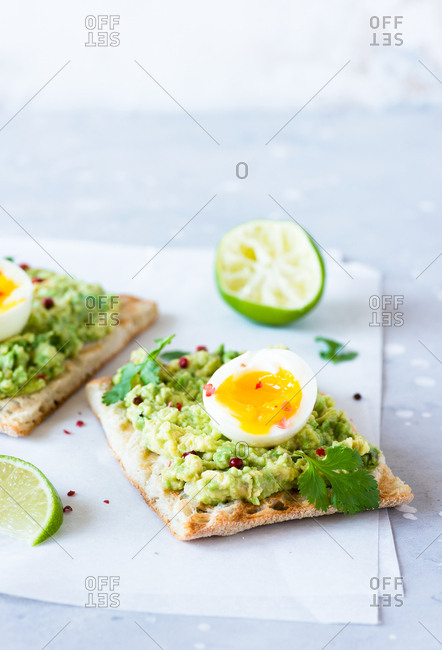 Avocado toast with soft-boiled eggs and lime