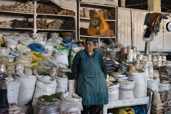 Cusco, Peru - April 4, 2019: Elderly woman vendor in San Pedro Market