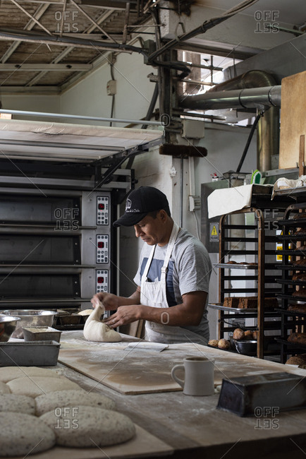 Cusco, Peru - April 2, 2019: Man working in a bread bakery