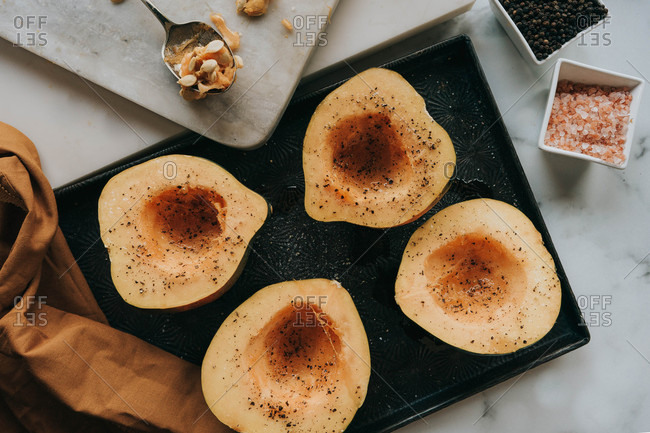 Overhead view of acorn squash on dark tray