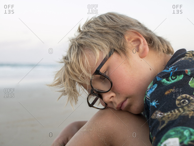 Boy daydreaming on a beach